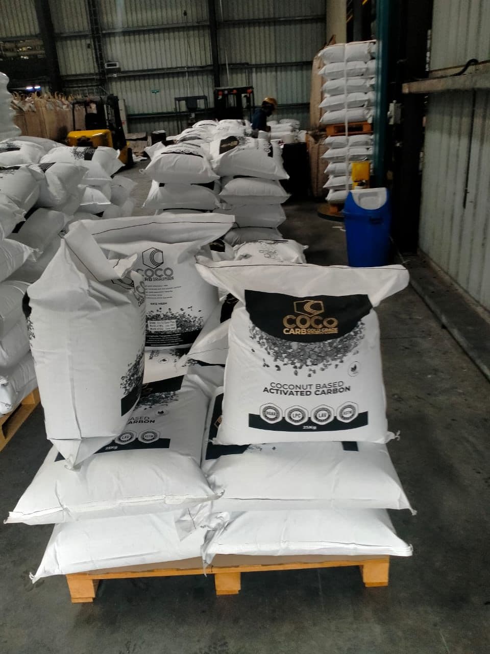 CocoCarb activated carbon bags stacked in warehouse, ready for export